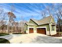 Exterior angle view displaying three-car garage, well-maintained lawn and attractive architectural details at 959 Tamary Way # 29/30, Landis, NC 28088