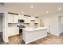 Modern kitchen with white cabinets, quartz countertops, and stainless steel appliances at 108 Mountain Bridge Way, Statesville, NC 28625