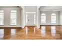 Bright foyer featuring gleaming hardwood floors, white trim, and arched windows letting in natural light at 373 Fischer Rd, Fort Mill, SC 29715