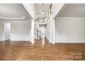 Spacious foyer featuring gleaming hardwood floors, grand staircase, and elegant trim at 373 Fischer Rd, Fort Mill, SC 29715