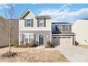 Two-story house with gray and beige siding, a two-car garage, and a landscaped lawn at 5117 Tinker Field Rd, Charlotte, NC 28215