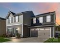 Two-story house with gray and beige siding, a two-car garage, and a landscaped lawn at 5117 Tinker Field Rd, Charlotte, NC 28215