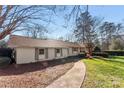 A charming single-story home with a spacious yard, mature trees, and a curved walkway at 946 Scotch Dr, Gastonia, NC 28054