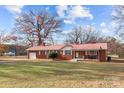 Brick ranch home with a metal roof and spacious yard at 955 Goodnight Rd, Salisbury, NC 28147