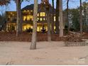 A backyard view of the home featuring a fountain, stone patio, and lake access at 1140 Inlet Pointe Rd, Salisbury, NC 28146