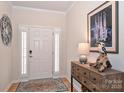 Front entry with stylish console table, hardwood floors, and plantation shutters at 2353 Abundance Ln, Waxhaw, NC 28173