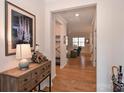 Bright and spacious entryway with hardwood floors and decorative console table at 2353 Abundance Ln, Waxhaw, NC 28173