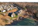 Community overview showing houses near a lake at 310 Pine St, Locust, NC 28097
