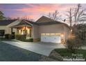 House exterior at sunset with a two-car garage at 310 Pine St, Locust, NC 28097