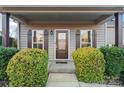 Inviting front entry with covered porch and lush landscaping at 310 Pine St, Locust, NC 28097