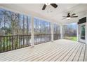 Covered back porch with black railing overlooking a tranquil waterfront view at 357 Triple Ponds Ct, Clover, SC 29710
