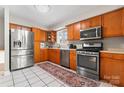 Well-equipped kitchen featuring stainless steel appliances, tile floors, and ample cabinet space at 1065 Gauguin Ln, Fort Mill, SC 29708