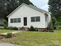 Inviting home with manicured lawn, landscaped garden beds, and a quaint front entrance at 155 6Th Sw St, Taylorsville, NC 28681