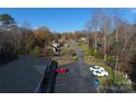 Aerial view of property showcasing a long drive with ample parking and mature trees at 194 E Jay Dr # 3, Taylorsville, NC 28681