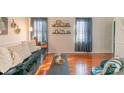 Sunlit living room showcasing hardwood floors and a relaxing couch at 405 Wakefield Dr # B, Charlotte, NC 28209