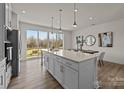 Bright eat-in kitchen with a large center island, modern cabinets and a sliding glass door to a balcony at 5019 Layman Dr # 26, Charlotte, NC 28226