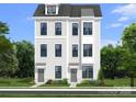 Modern three-story townhome featuring light siding, neutral trim, and professional landscaping at 5027 Layman Dr # 24, Charlotte, NC 28226