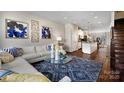 Open-concept layout featuring a comfortable sofa, modern decor, and seamless flow to the kitchen at 5027 Layman Dr # 24, Charlotte, NC 28226