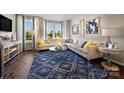 Cozy living room showcasing a plush sectional sofa, stylish rug, and abundant natural light at 5027 Layman Dr # 24, Charlotte, NC 28226