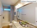 Bathroom with granite vanity, tub shower combo and large mirror at 2015 Canvasback Way, Indian Trail, NC 28079
