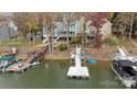 Waterfront backyard with private docks, wooden walkways, and lush landscaping leading to a serene lake view at 26022 Misty Way Dr, Tega Cay, SC 29708