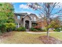 Two-story brick home with stone accents and landscaping at 16515 Governors Club Ct, Charlotte, NC 28278