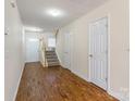 Bright foyer with hardwood floors, staircase, and a convenient coat closet at 1305 Penny Oaks Cv, Rock Hill, SC 29732