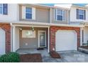 Inviting front entrance with brick accents, covered porch, and well-manicured landscaping at 1305 Penny Oaks Cv, Rock Hill, SC 29732