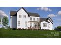 A spacious backyard featuring a covered patio, perfect for enjoying outdoor living at 229A Ballard Ct, Fort Mill, SC 29715