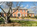 Charming two-story brick home featuring mature landscaping and a well-manicured front lawn at 3513 Country Club Dr, Gastonia, NC 28056