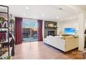Bright living room with fireplace, sliding glass door leading to the backyard, and modern furnishings at 5300 Fair Wind Ln, Charlotte, NC 28212