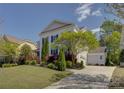 View of the side of the house, driveway, and detached garage showcasing the home's layout at 10029 Daufuskie Dr, Charlotte, NC 28278