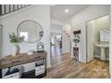 Bright entryway with hardwood floors, a half-bath, and a large mirror at 109 Watrous Way, Mooresville, NC 28115