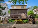 Inviting backyard with a large wooden deck, screened porch, and relaxing hammock at 1655 Scotland Ave, Charlotte, NC 28207