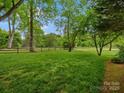 Spacious backyard with well-maintained lawn and mature trees, perfect for outdoor activities at 1655 Scotland Ave, Charlotte, NC 28207