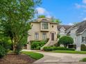 Charming home featuring manicured landscaping and an elegant curved stairway to the front door at 1655 Scotland Ave, Charlotte, NC 28207