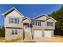 Two-story house with gray siding, stone accents, and a two-car garage at 2061 Gary Ln, Hickory, NC 28602