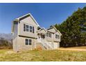 Two-story house with gray siding, stone accents, and a front porch at 2061 Gary Ln, Hickory, NC 28602