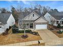 Inviting home featuring a well-manicured lawn, brick and siding exterior, and an attached garage at 2481 Bergamot St, Tega Cay, SC 29708