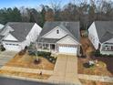 Charming home with a well-maintained yard, brick and siding exterior, and a two-car garage at 2481 Bergamot St, Tega Cay, SC 29708