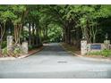 Community entrance with stone pillars and landscaping, creating a welcoming and elegant entry to the neighborhood at 2605 Willowdale Ln, Matthews, NC 28105
