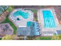 Aerial view of community pool area with multiple pools, lounge chairs, and a playground, offering diverse recreation at 2605 Willowdale Ln, Matthews, NC 28105