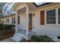Updated ranch home exterior with white brick, wood shutters, and a covered porch at 1402 Springdale Park Dr, Lincolnton, NC 28092
