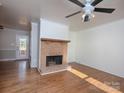 Living room with hardwood floors and brick fireplace at 5315 Ruth Dr, Charlotte, NC 28215