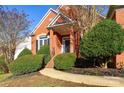 Front entry of a brick house with bushes and a walkway at 5839 Painted Fern Ct, Charlotte, NC 28269