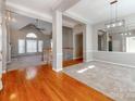 Two story entry with hardwood floors, neutral paint, and views to the Gathering room at 5839 Painted Fern Ct, Charlotte, NC 28269
