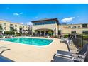 Community pool with lounge chairs and tables, great for relaxing or entertaining at 721 Governor Morrison St # 425, Charlotte, NC 28211