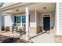 Cozy covered porch with rocking chairs, creating a welcoming entry to the home at 7669 Tanglewood Way, Denver, NC 28037