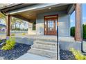 Close-up of the front porch featuring a wooden door with glass panels at 901 Edgemont Ave, Belmont, NC 28012
