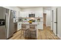 Modern kitchen featuring stainless steel appliances, white cabinets, and a central island with seating at 1423 Roseland Dr, Lincolnton, NC 28092